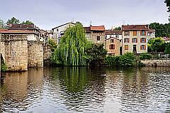 alte Häuser am Flußufer mit Brücke